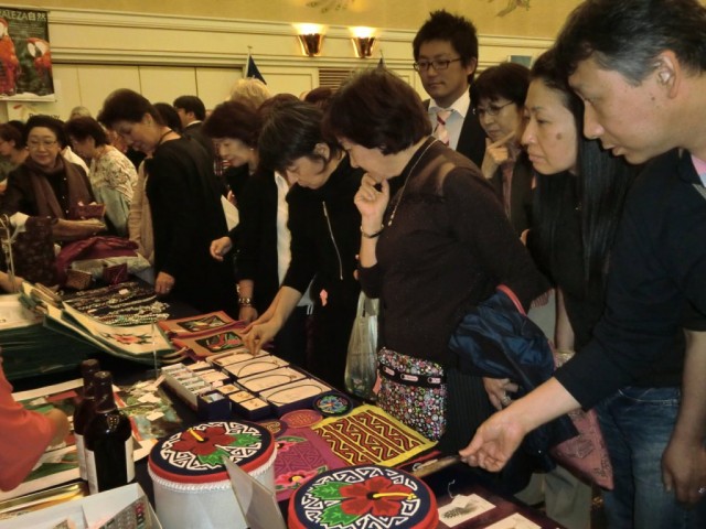 Visitors looking at the Panamanian handicrafts exhibited at the booth